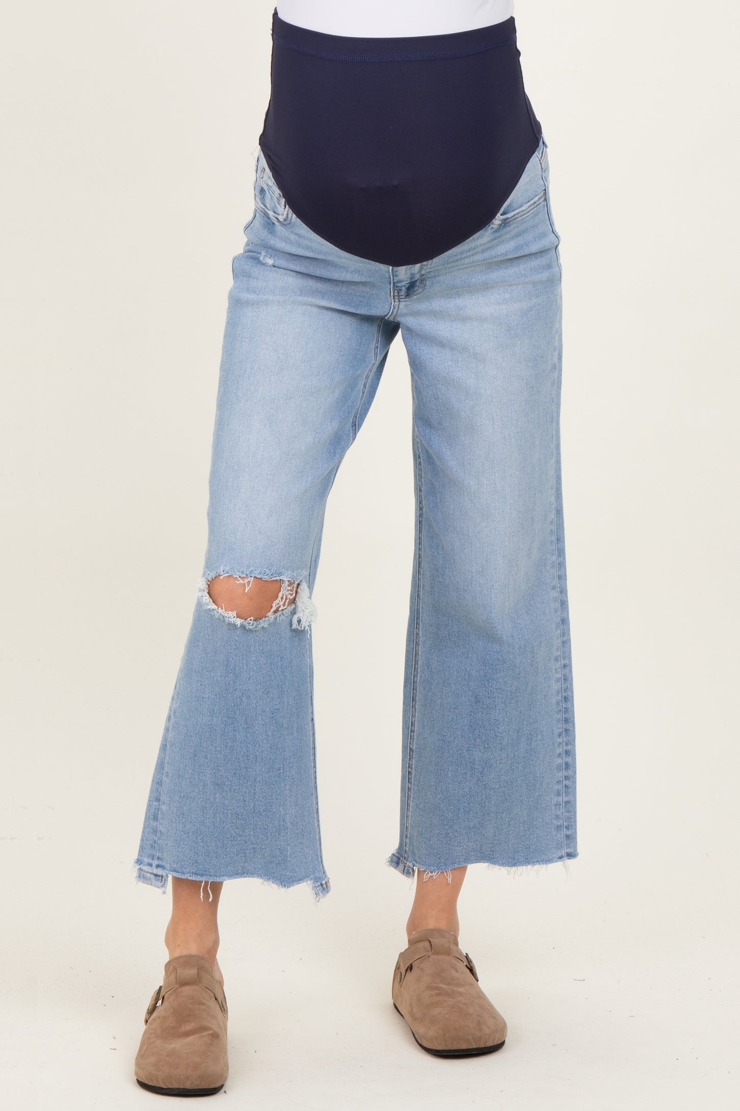 maternity wear blue distressed high-waisted flared jeans with a stretchy waistband and visible baby bump