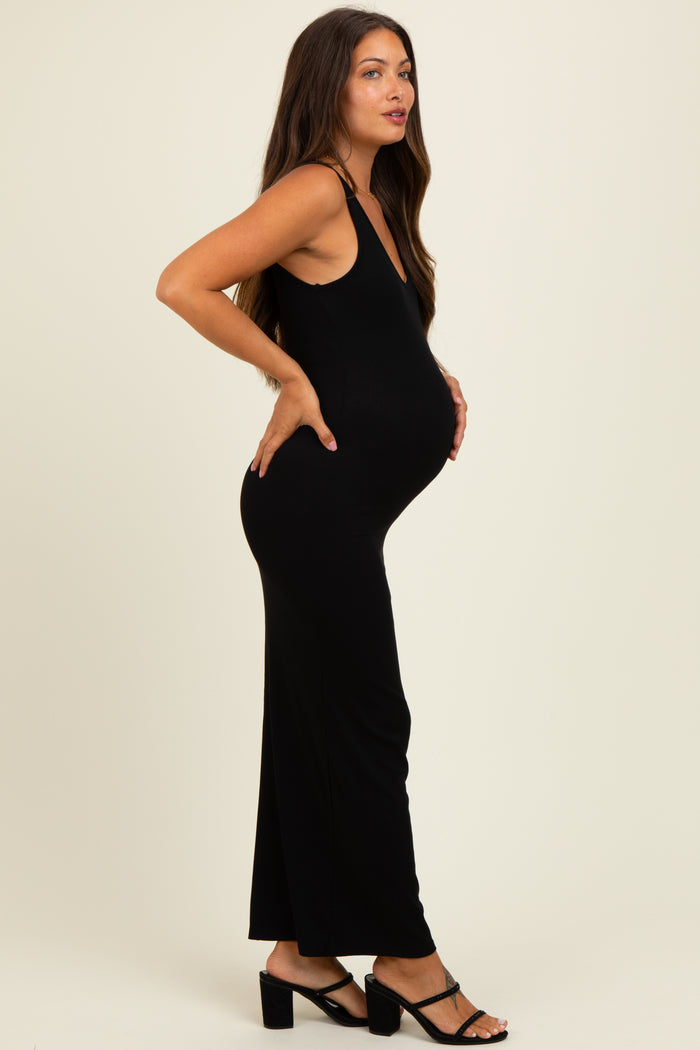 woman wearing a black ribbed maternity maxi dress with a visible baby bump