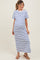 woman wearing a white maternity dress with blue stripes and a visible baby bump