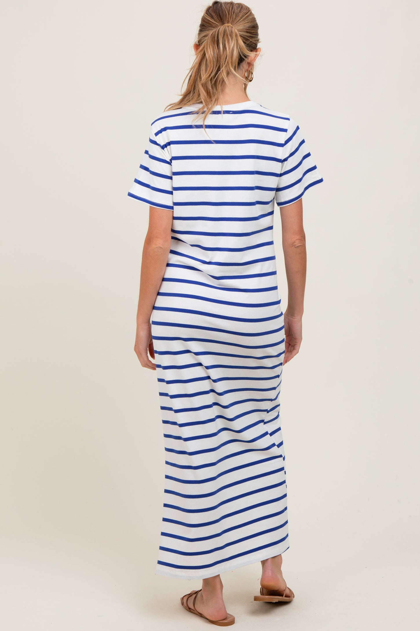woman wearing a white and blue striped maternity maxi dress with short sleeves and a relaxed fit