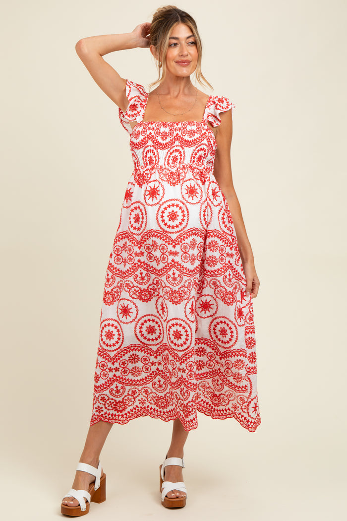 woman wearing a red and white floral print maternity dress with short sleeves and a square neckline