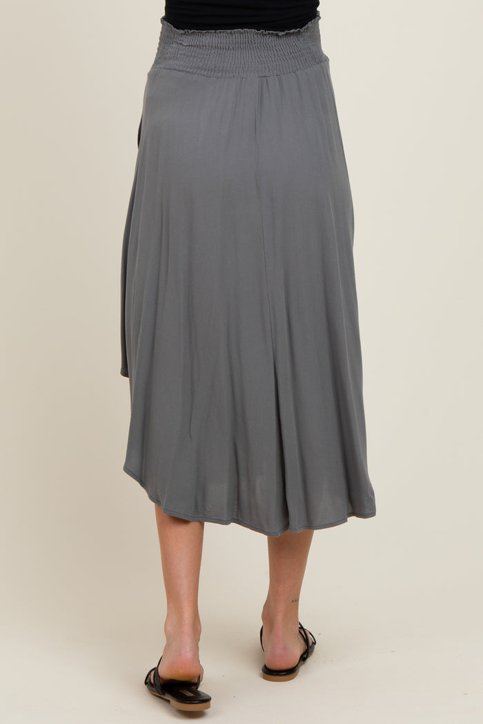 woman wearing a gray maxi maternity skirt with a smocked waistband, seen from the back