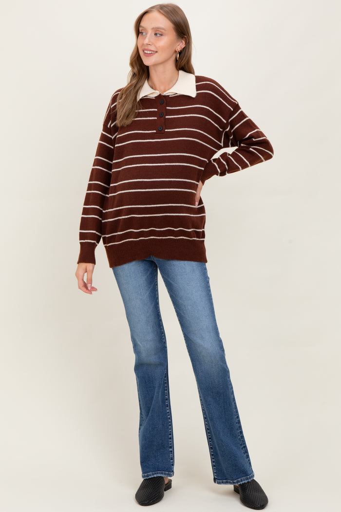 woman wearing a brown and cream striped maternity sweater with a collared neckline, paired with flared jeans