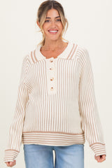 woman wearing a cream and tan striped maternity sweater with a collar and button detail