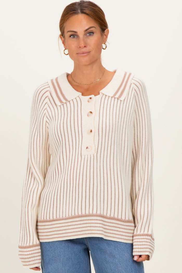woman wearing a cream and brown striped sweater with a collar and button details