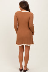 woman wearing a brown ribbed maternity dress with a ruffled hem and long sleeves, shown from the back