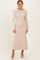 woman wearing a long sleeve light beige knit maxi dress with a decorative cowl neckline