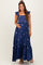 woman wearing a navy blue maternity maxi dress with floral embroidery and ruffled sleeves, showing her baby bump
