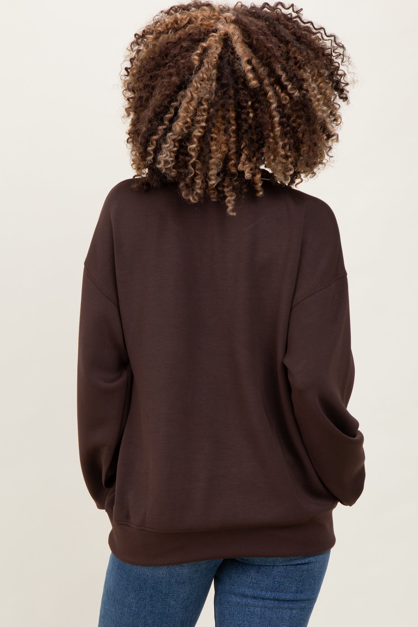 woman wearing a dark brown maternity sweatshirt with a relaxed fit and long sleeves, viewed from the back