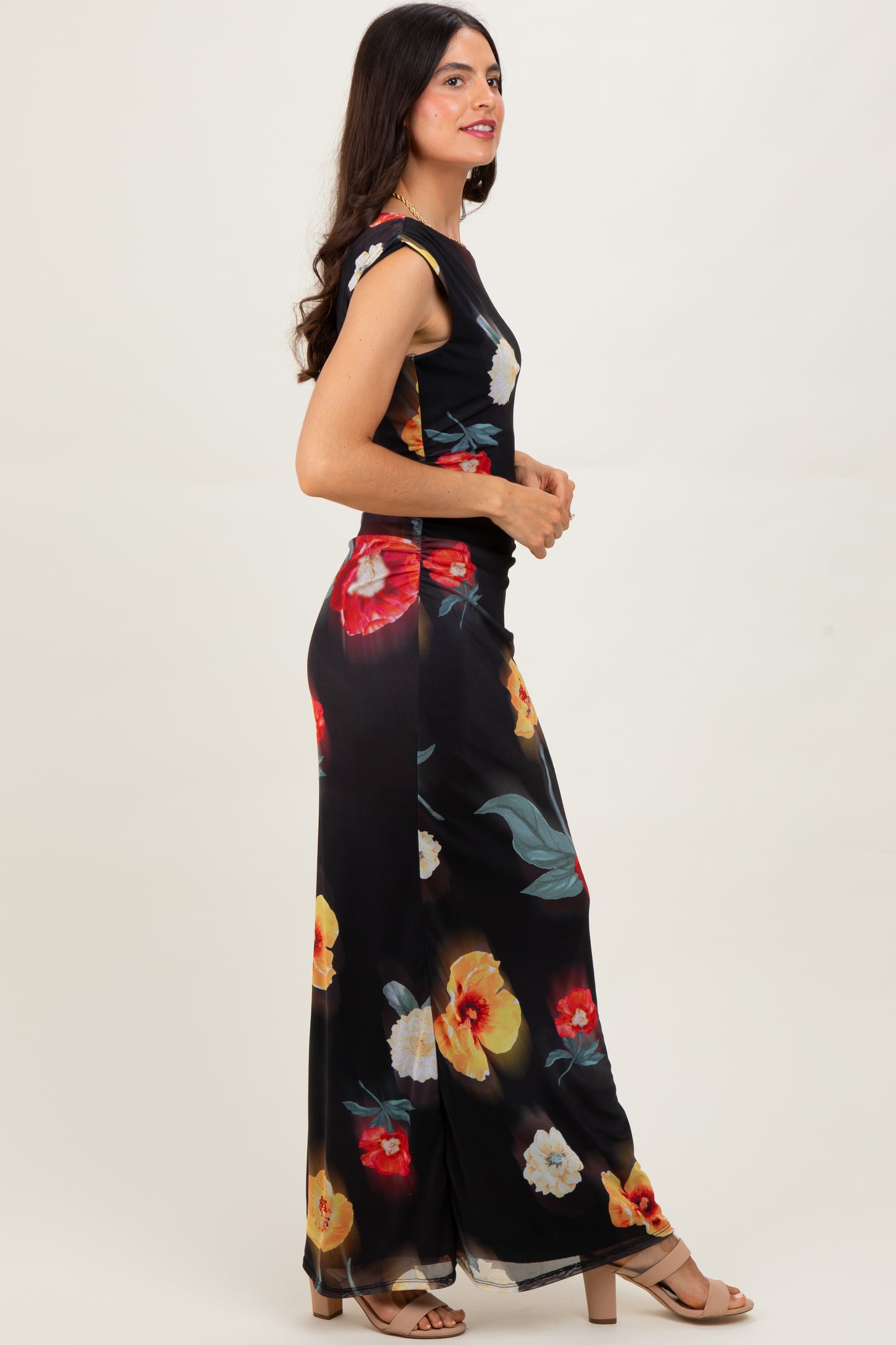 woman wearing a black floral maxi dress with short sleeves and a fitted bodice