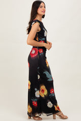 woman wearing a black floral maxi dress with short sleeves and a fitted bodice