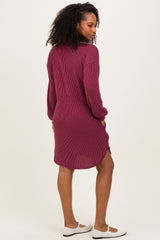 woman wearing a burgundy ribbed long sleeve dress with a collar and side slits, shown from the back
