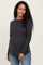 woman wearing a charcoal gray maternity long sleeve top with side slits and a visible baby bump