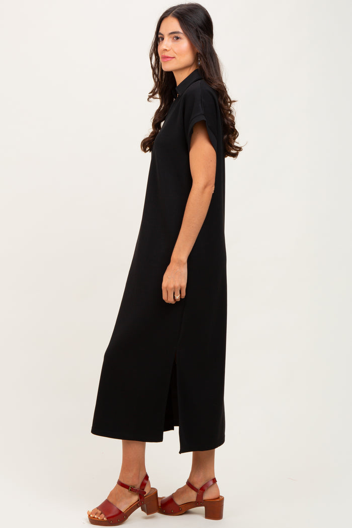 woman wearing a black midi dress with short sleeves and side slits, styled with red heeled sandals