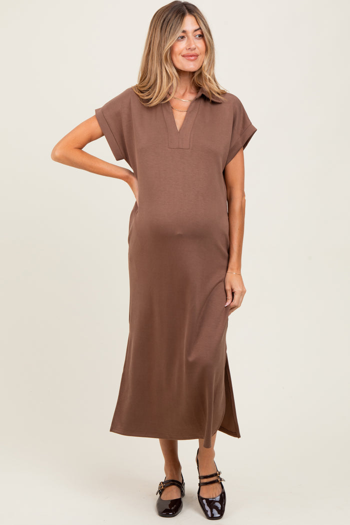 woman wearing a brown short sleeve maternity dress with a v-neck and side slits, showing her baby bump