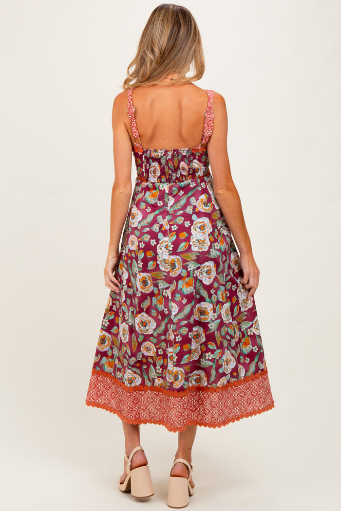 woman wearing a floral print maternity maxi dress with spaghetti straps and a detailed hemline, showing a relaxed fit