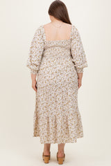 woman wearing a floral print maternity plus dress with a smocked back and tiered hem, shown from the back