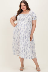 woman wearing a white and blue floral maternity dress with puff sleeves and a square neckline, showing her baby bump