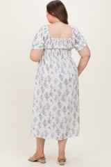 woman wearing a floral print maternity plus dress with puff sleeves and a square back, showing her baby bump