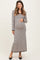 woman wearing a black and cream striped maternity maxi dress and holding her baby bump