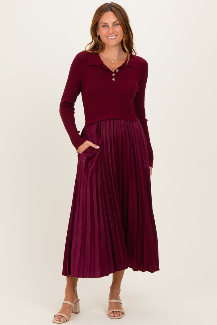 woman wearing a burgundy ribbed sweater with a collared neckline and a pleated midi skirt with pockets