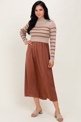 woman wearing a beige and rust striped cropped sweater and a rust pleated midi skirt with slip-on sandals