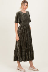 woman wearing an olive green crushed velvet midi dress with short sleeves and ruffle hem details