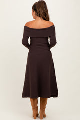 woman wearing a chocolate brown off-shoulder maternity dress, shown from the back, with a fitted bodice and flared skirt