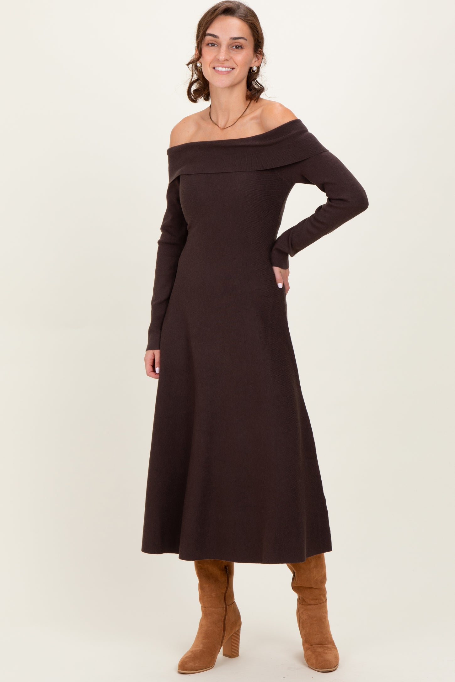 woman wearing a brown off-the-shoulder long sleeve dress and tan knee-high boots