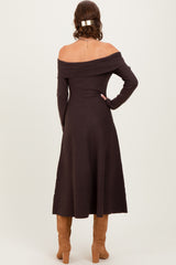 woman wearing a chocolate brown off-the-shoulder midi dress with long sleeves and a fitted silhouette