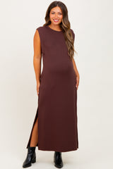 woman wearing a brown sleeveless maxi maternity dress with side slits and a baby bump visible