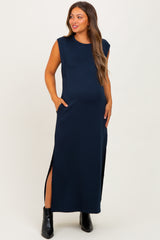 woman wearing a navy blue sleeveless maternity maxi dress with side pockets and high slits