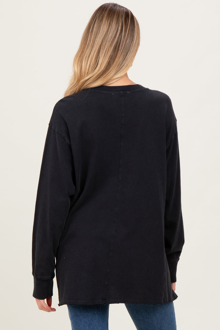 woman wearing a black long sleeve maternity top, back view, with a relaxed fit and side slits
