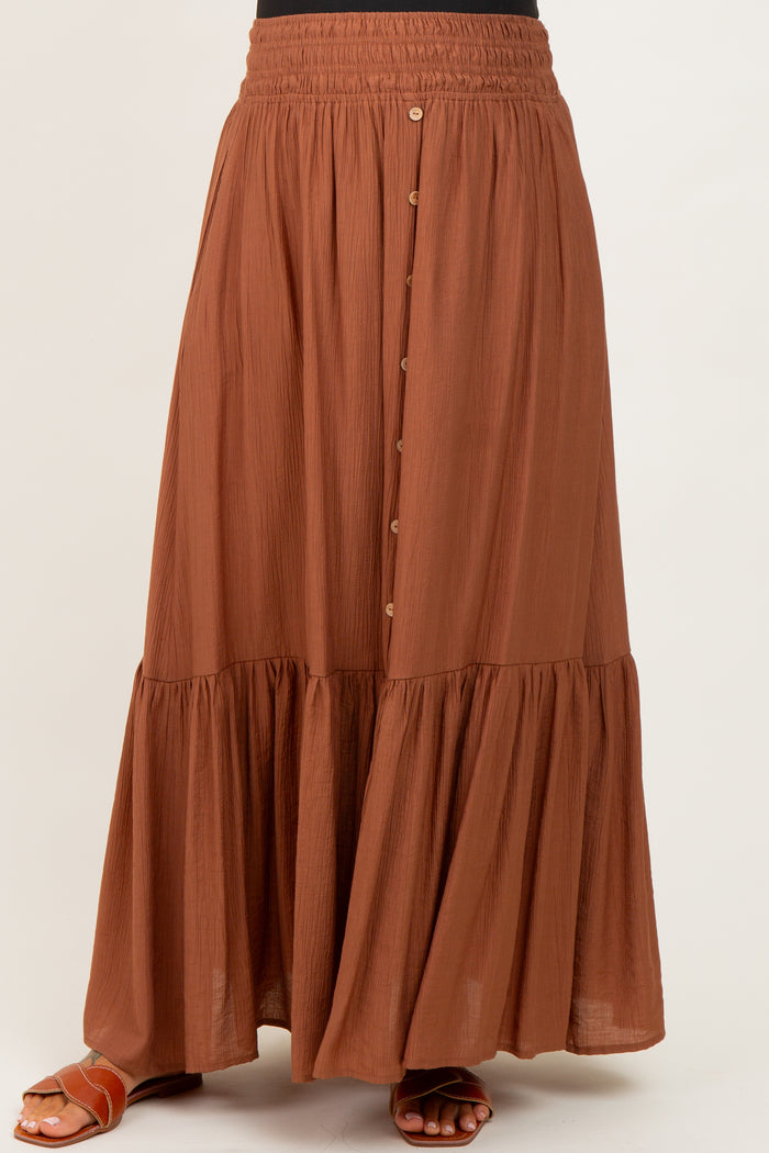 maternity wear rust colored maxi skirt with button details and tiered ruffle hem, model not wearing a baby bump visible
