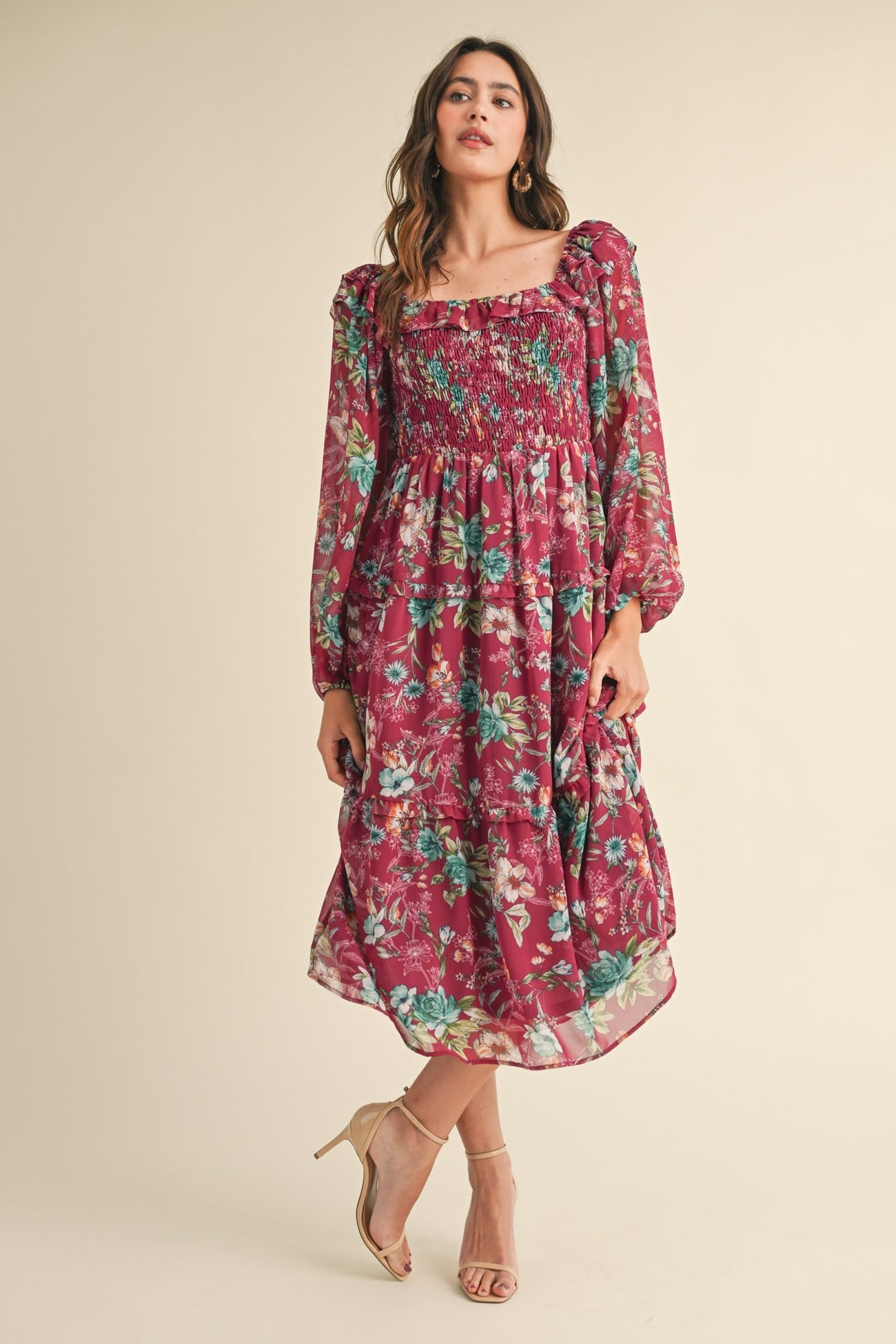 woman wearing a burgundy floral maxi dress with puff sleeves and smocked bodice