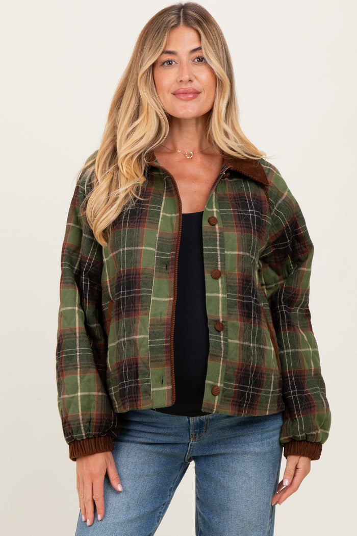 woman wearing a green and brown plaid maternity jacket with a relaxed fit and button closure over a black top