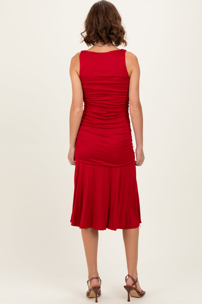 woman wearing a red fitted sleeveless dress with ruching and a flared hem, shown from the back