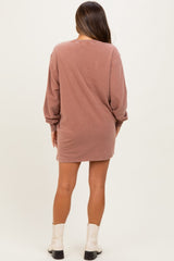 woman wearing a dusty rose long sleeve maternity dress, showing a relaxed fit and reaching mid-thigh length
