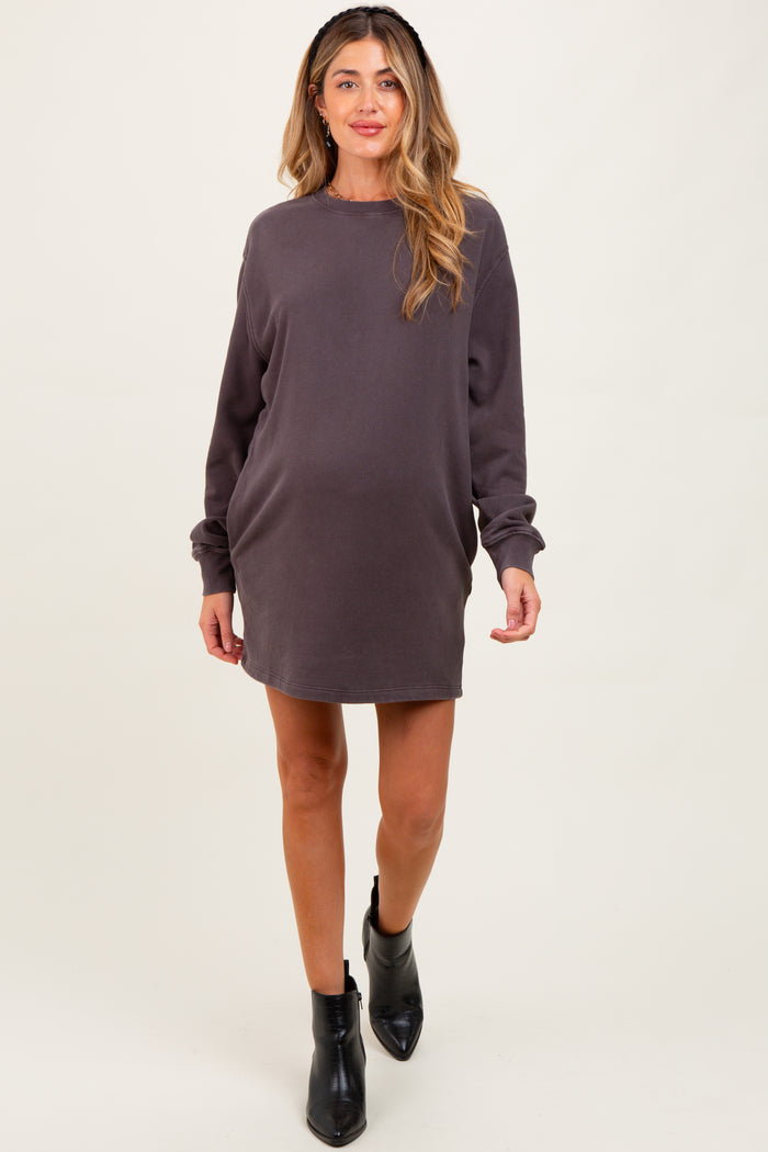 woman wearing a dark gray maternity sweatshirt dress with long sleeves and a relaxed fit, showing her baby bump