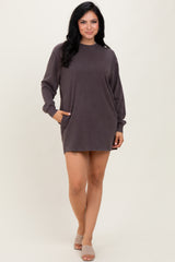 woman wearing a dark mauve long sleeve oversized sweatshirt dress with pockets