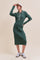 woman wearing a green ribbed midi dress with a collar and button detail, paired with a white cap and sneakers