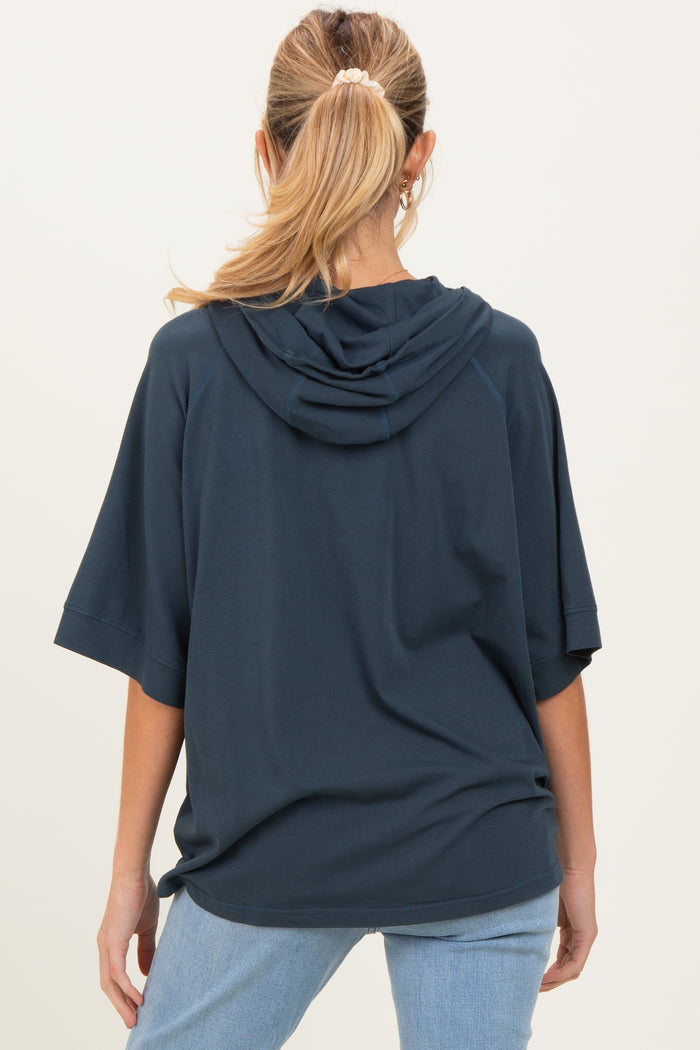woman wearing a navy blue oversized hoodie with a hood, shown from the back, maternity wear