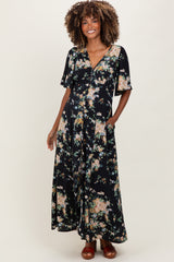 woman wearing a black floral maternity maxi dress with short sleeves and pockets