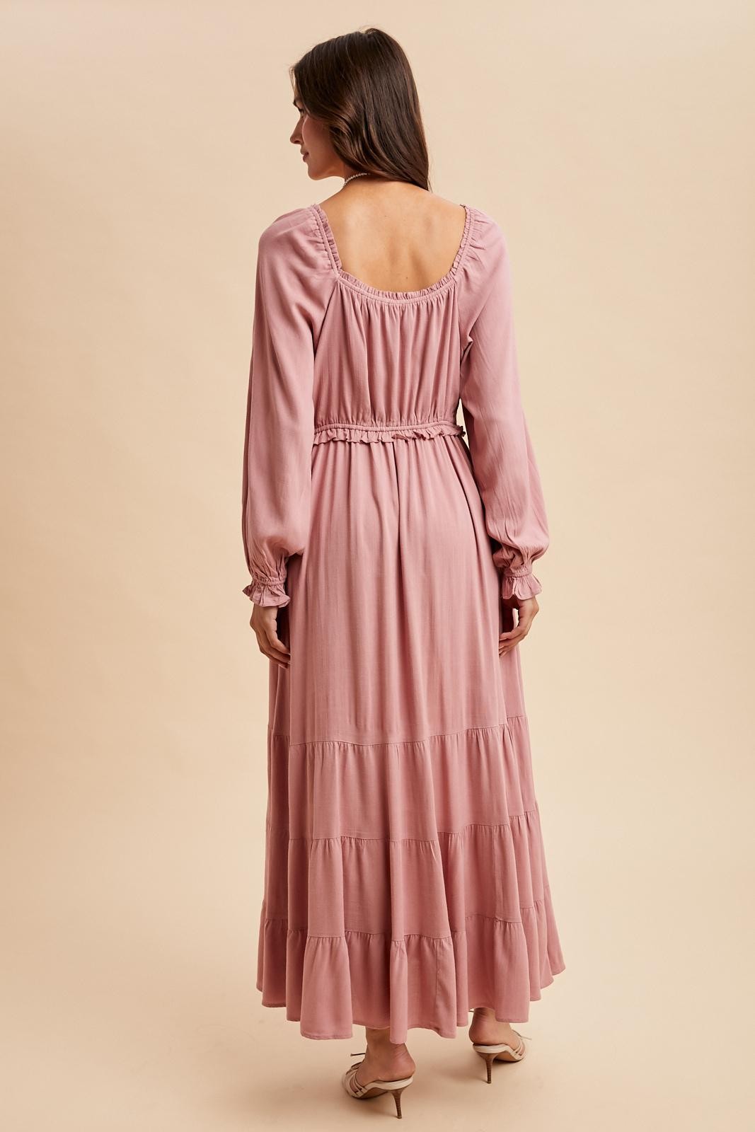 women's long sleeve dusty pink maxi dress with ruffled tiers and an elastic waist, shown from the back