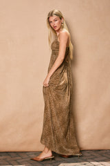 woman wearing a brown leopard print maxi dress with a fitted bodice and flowing skirt