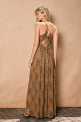 woman wearing a brown leopard print maxi dress with a crisscross back and pleated detailing