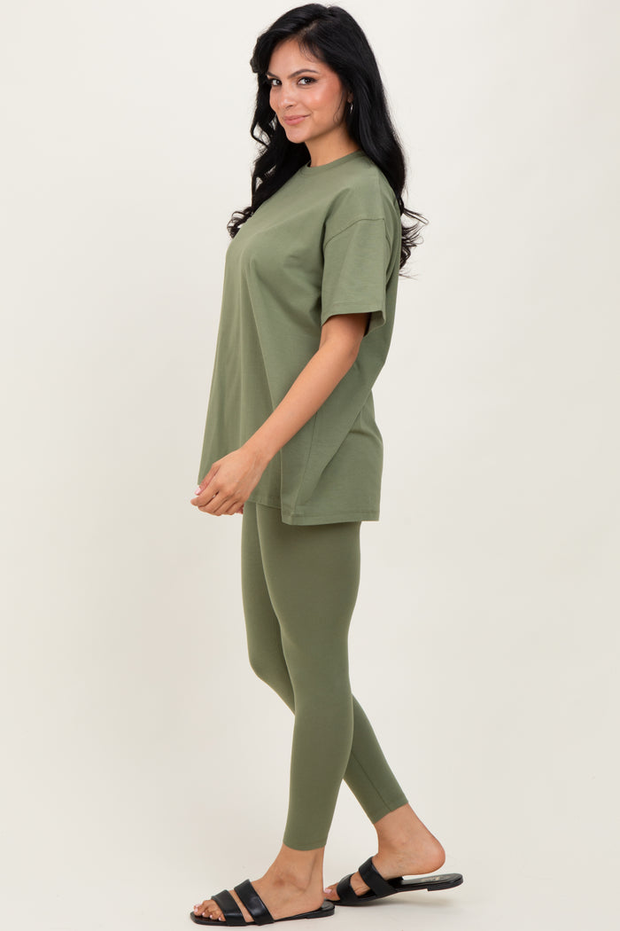woman wearing an olive green oversized t-shirt and matching fitted leggings with open-toe sandals