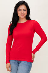 woman wearing a long sleeve bright red top with a fitted style and crew neckline