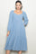 woman wearing a light blue polka dot midi dress with puff sleeves and a square neckline