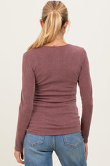 woman wearing a ribbed mauve maternity top with a fitted silhouette, shown from the back